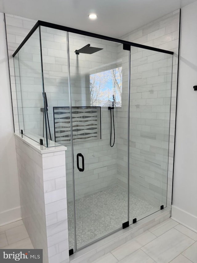 bathroom with tile patterned floors and walk in shower