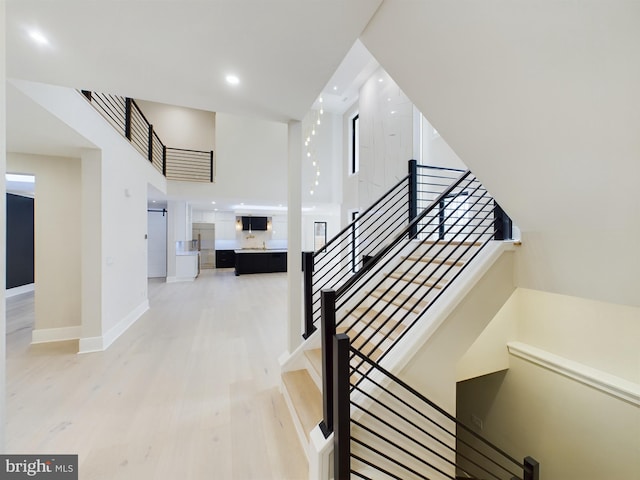 5005 Ravensworth Rd, Annandale, VA 22003 - staircase with wood finished floors, baseboards, and recessed lighting