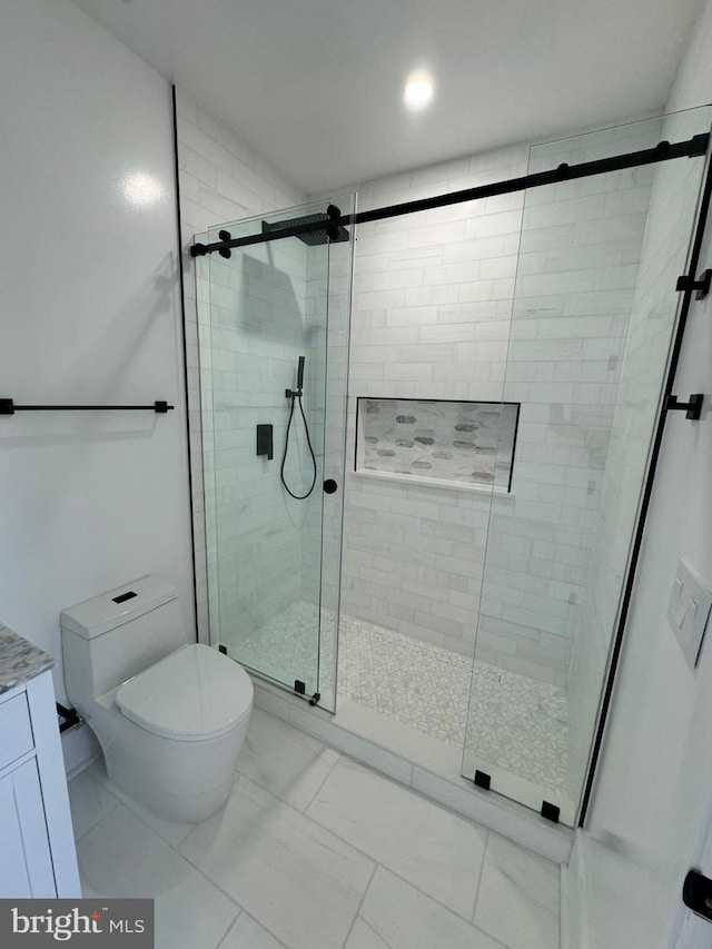 bathroom with an enclosed shower and toilet