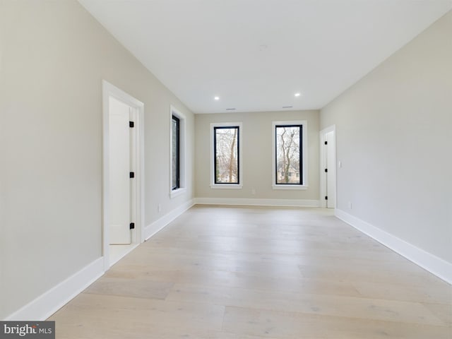 spare room featuring light wood-type flooring