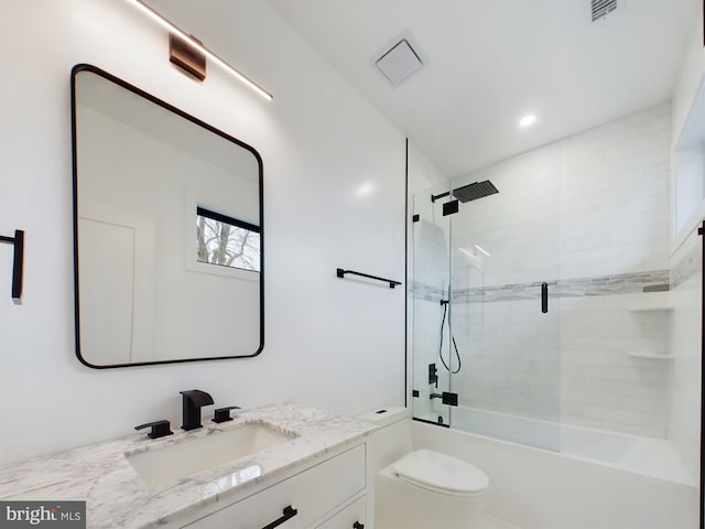 full bathroom featuring vanity, toilet, and enclosed tub / shower combo