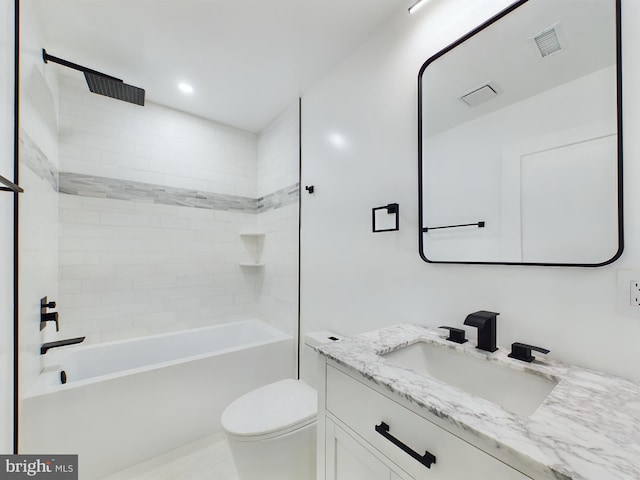 full bathroom featuring vanity, toilet, and tiled shower / bath