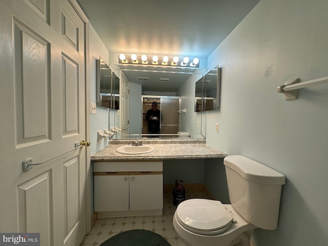 bathroom featuring walk in shower, vanity, and toilet