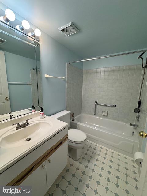 full bathroom featuring vanity, toilet, and tiled shower / bath combo