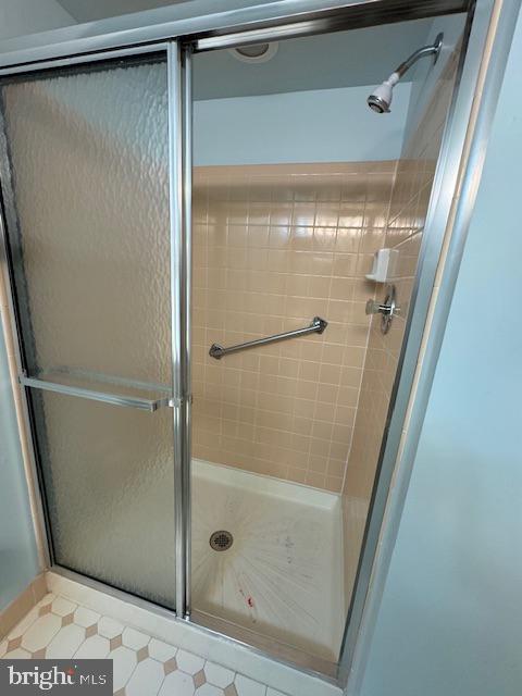 bathroom featuring a shower with door