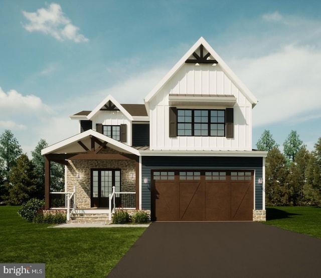 view of front of property featuring a garage and a front lawn