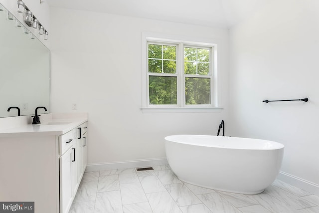 bathroom featuring vanity and a bath