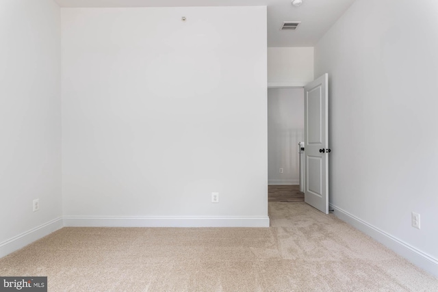 empty room featuring light carpet