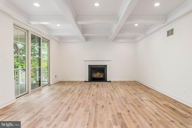 unfurnished living room featuring beamed ceiling, coffered ceiling, and light hardwood / wood-style flooring