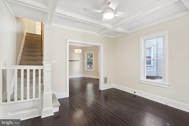 spare room featuring coffered ceiling, beamed ceiling, and dark hardwood / wood-style flooring