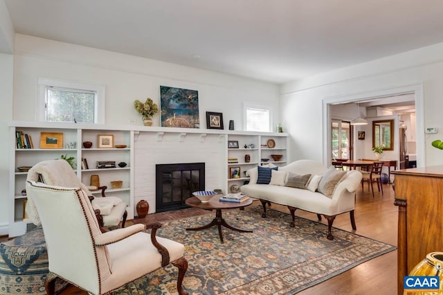 living room with hardwood / wood-style flooring and a fireplace