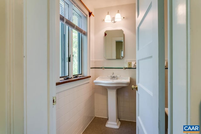 bathroom with tile patterned floors and tile walls