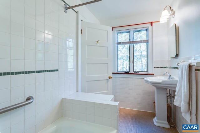 bathroom featuring tile walls, plus walk in shower, and tile patterned flooring