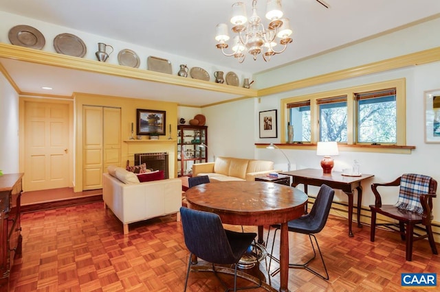 dining area with parquet flooring, a chandelier, and crown molding