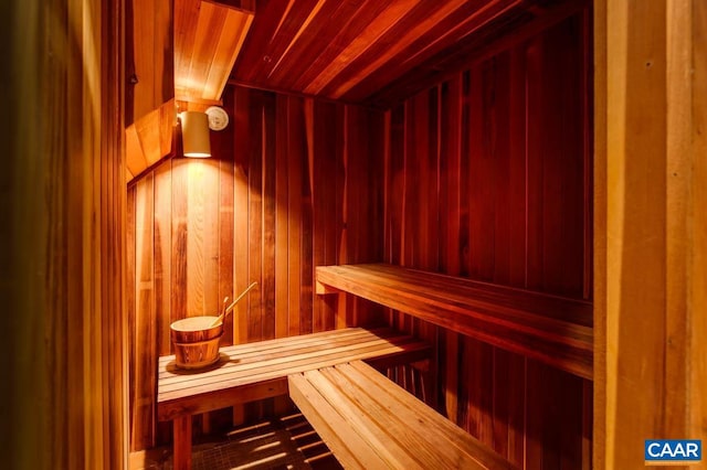 view of sauna / steam room featuring wood ceiling and wood walls