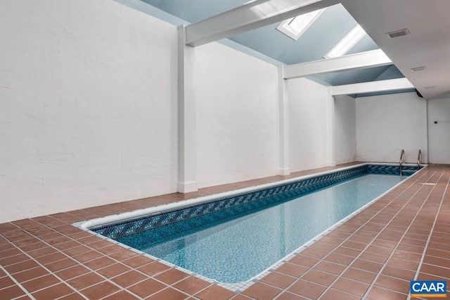 view of swimming pool featuring a skylight