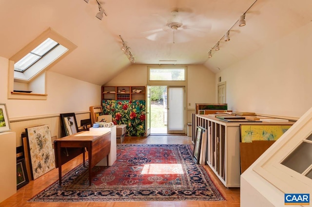 bonus room featuring lofted ceiling with skylight and ceiling fan