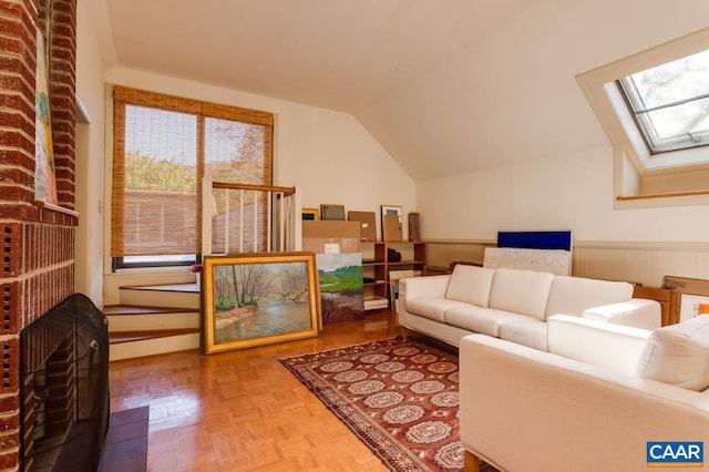 living room with parquet flooring, vaulted ceiling with skylight, and a healthy amount of sunlight