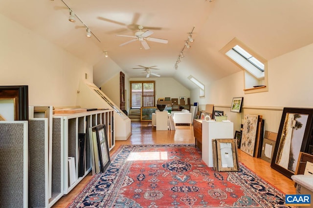 bonus room with vaulted ceiling with skylight, hardwood / wood-style flooring, and ceiling fan