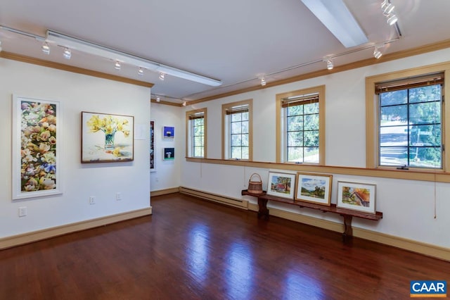 interior space with baseboard heating, ornamental molding, and dark hardwood / wood-style flooring