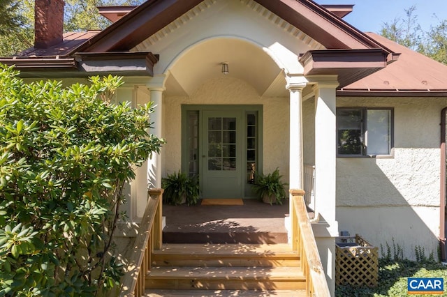 view of exterior entry with a deck