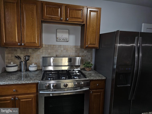 kitchen featuring backsplash, stone counters, and stainless steel appliances