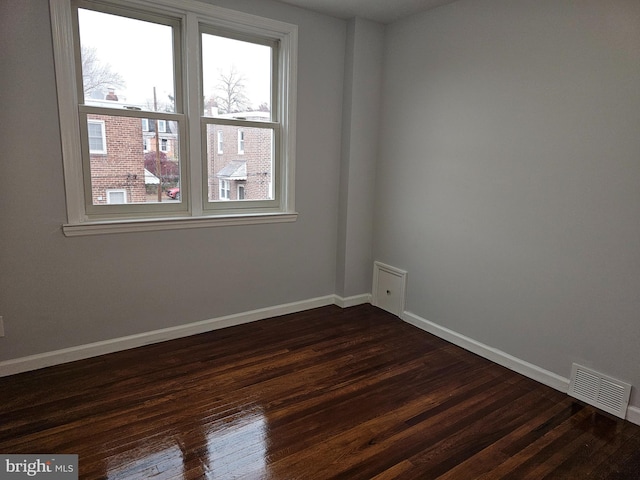 spare room featuring dark hardwood / wood-style flooring