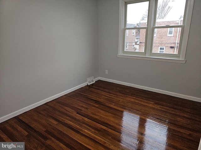 empty room featuring dark wood-type flooring