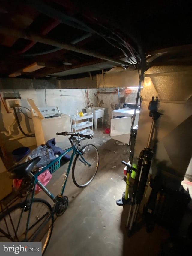 basement with sink and washer and clothes dryer