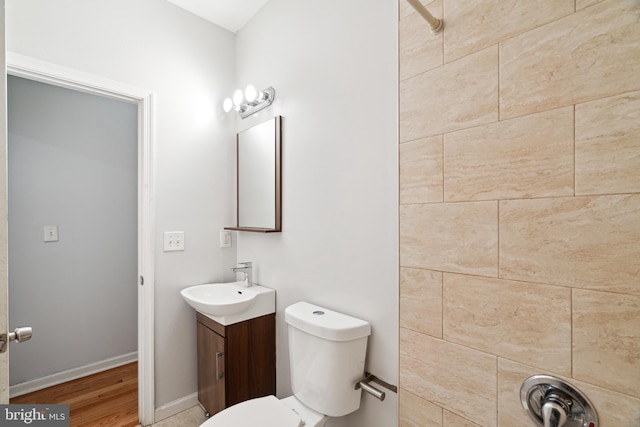 bathroom with vanity, hardwood / wood-style floors, and toilet