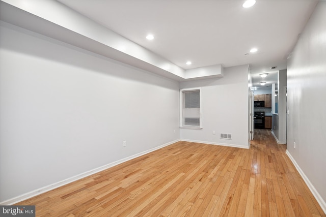 basement with light hardwood / wood-style floors