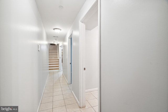 hall with light tile patterned floors