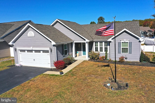 view of front of property featuring a front yard and a garage