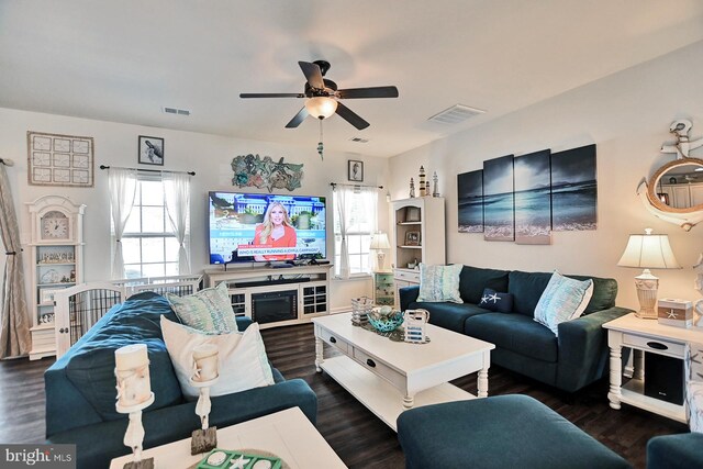 living room with ceiling fan and dark hardwood / wood-style flooring