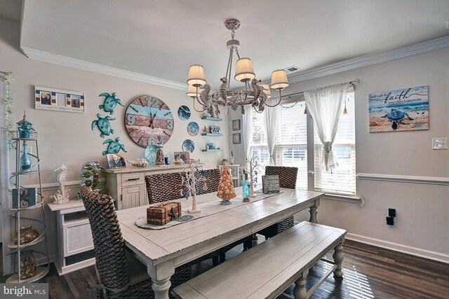 dining space featuring ornamental molding, dark wood-type flooring, and an inviting chandelier