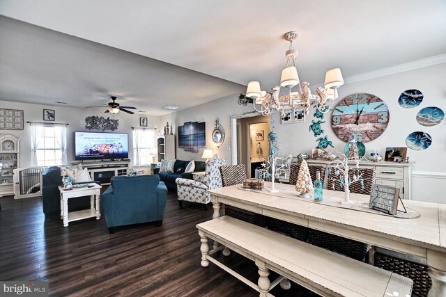 dining space featuring ornamental molding, dark hardwood / wood-style flooring, and ceiling fan with notable chandelier