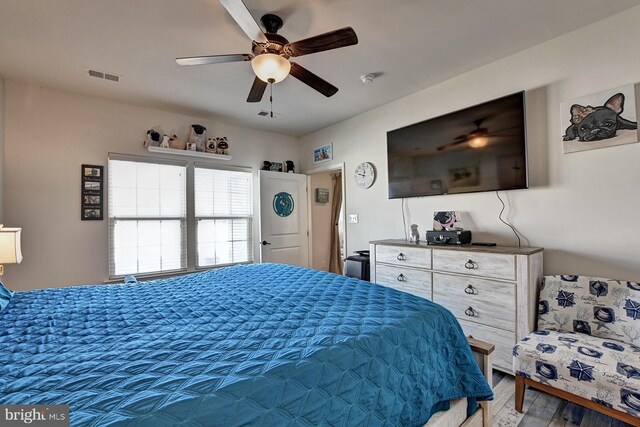 bedroom with ceiling fan and hardwood / wood-style flooring