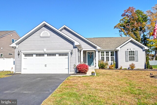 single story home featuring a garage and a front lawn