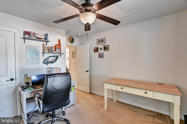 carpeted office space with ceiling fan