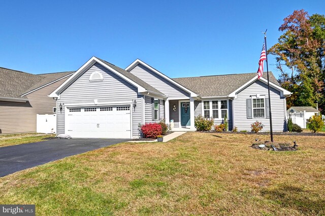 single story home featuring a front yard and a garage