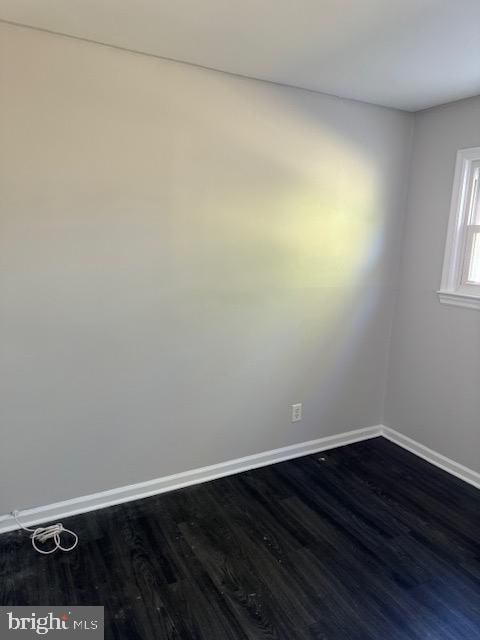 empty room featuring dark wood-type flooring