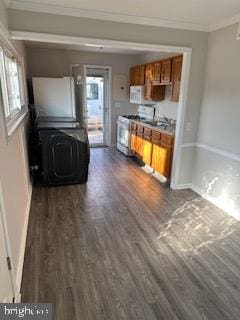 kitchen featuring crown molding, sink, dark hardwood / wood-style floors, and white appliances