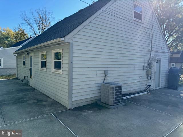 view of property exterior featuring cooling unit and a patio