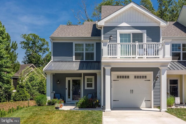 view of front of home with a garage, a balcony, and a front yard