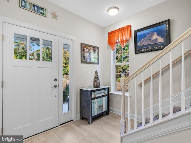 foyer with light wood-type flooring and plenty of natural light