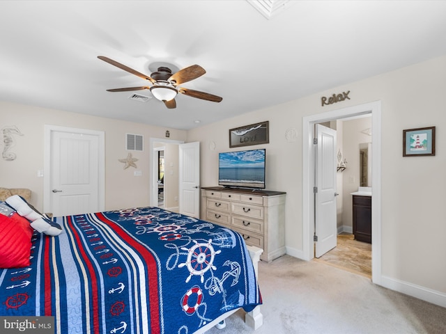 bedroom featuring ensuite bathroom, ceiling fan, and light colored carpet