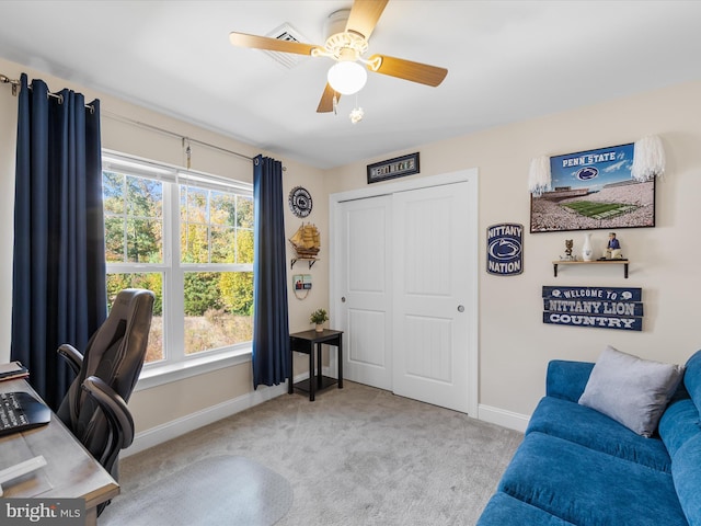 home office with light carpet and ceiling fan