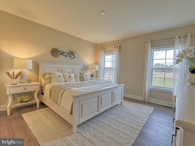 bedroom featuring light hardwood / wood-style flooring and multiple windows