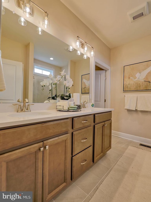 bathroom featuring vanity, tile patterned floors, and a shower with door