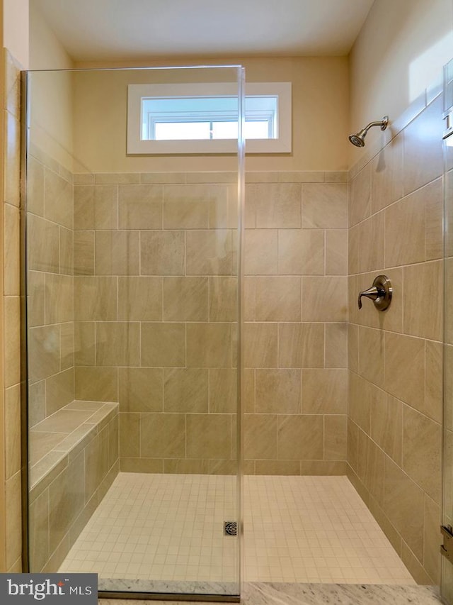 bathroom with a shower with door